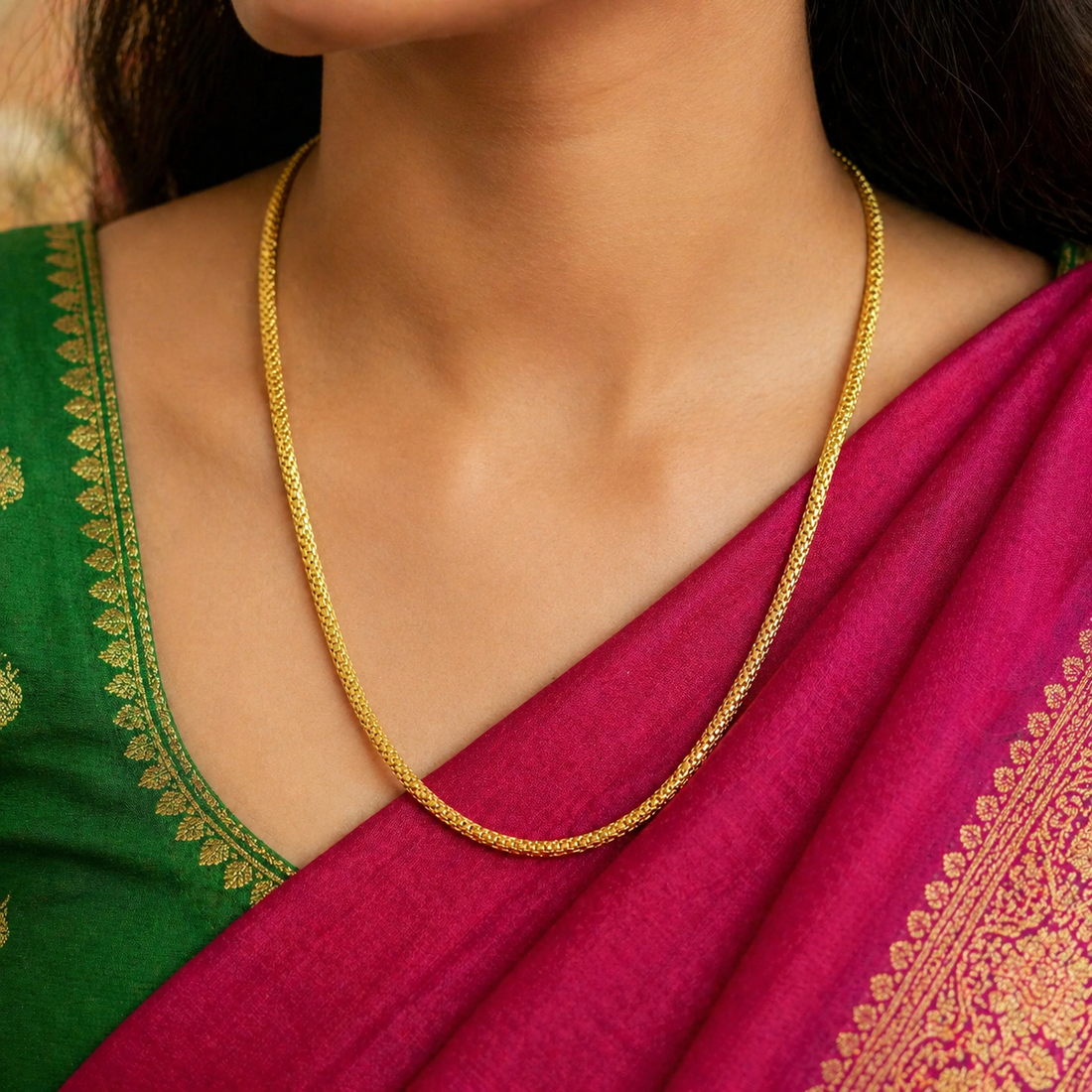 Gold chain necklace on a red background