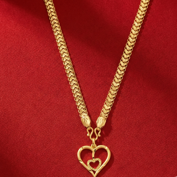 Gold necklace with a heart-shaped pendant on a red background