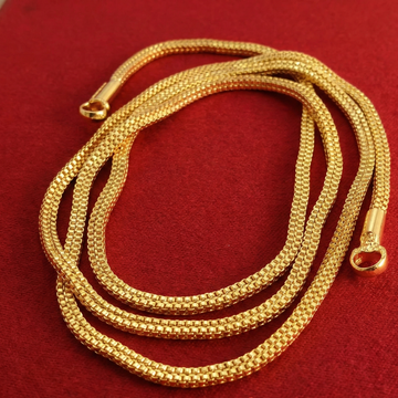 Gold chain necklace on a red background